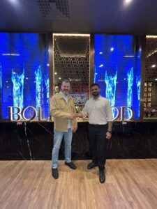 Neels Fourie, Director of FibreMax, shaking hands with Sunny, owner of Bollywood Indian Cuisine, Innaloo