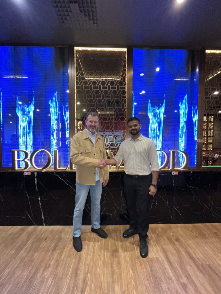 Neels Fourie, Director of FibreMax, shaking hands with Sunny, owner of Bollywood Indian Cuisine, Innaloo